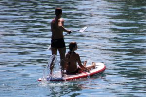 2 people on a paddleboard on the lake